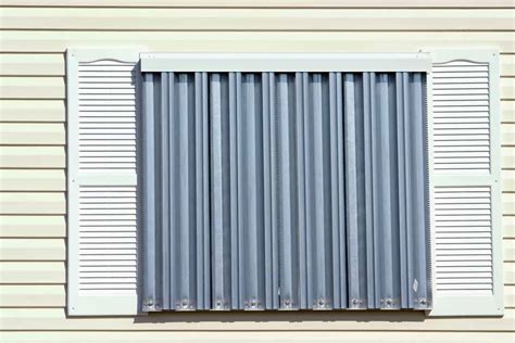 how to hang metal hurricane shutters on wood frame house|how to secure hurricane shutters.